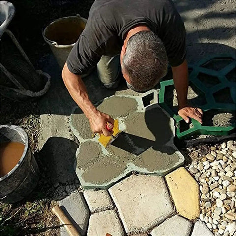 Man using Heavy Duty Concrete Molds Large Size For DIY Paving, Reusable Cement Molds For Patio And Garden Paths to create stepping stones.