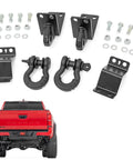 Rear Shackle Kit Beefed Up With D Rings And Rubber Isolators For Seven Eighths Pins Gloss Black Powder Coat Easy Bolt On Install Clamps To Factory Rear Crossmember Laminated Plate Design With One Half Inch Inner Plate And Seven Gauge Outer Plates, including bolts and installation view on red truck.