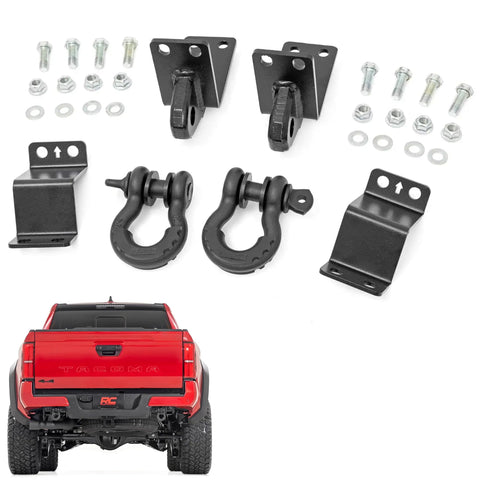 Rear Shackle Kit Beefed Up With D Rings And Rubber Isolators For Seven Eighths Pins Gloss Black Powder Coat Easy Bolt On Install Clamps To Factory Rear Crossmember Laminated Plate Design With One Half Inch Inner Plate And Seven Gauge Outer Plates, including bolts and installation view on red truck.