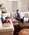 Living room with Bamboo Room Divider Folding Privacy Screen, 4 Panel, 72 Inches High and 17.7 Inches Wide behind couch and table.
