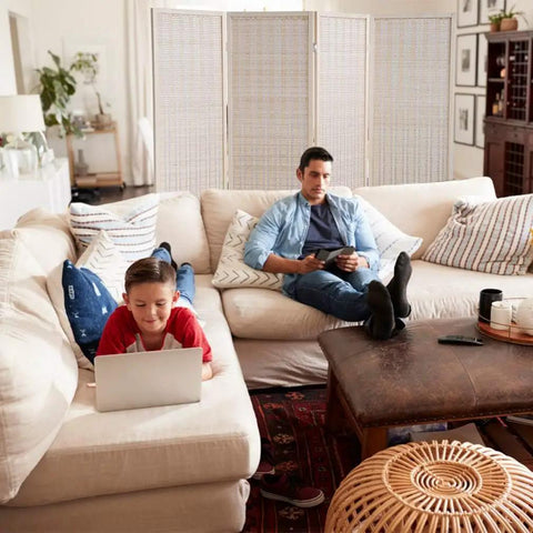 Living room with Bamboo Room Divider Folding Privacy Screen, 4 Panel, 72 Inches High and 17.7 Inches Wide behind couch and table.