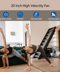 Two people doing yoga indoors with a Heavy Duty 20 Inch Floor Fan With High Velocity Airflow, 3 Speeds And Adjustable Tilting Head in the corner.