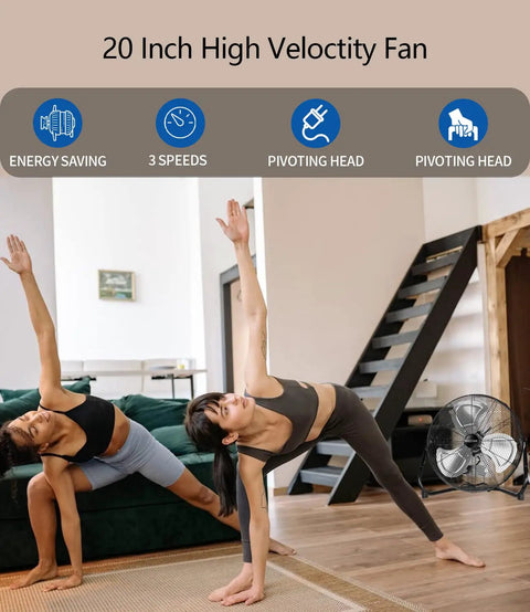 Two people doing yoga indoors with a Heavy Duty 20 Inch Floor Fan With High Velocity Airflow, 3 Speeds And Adjustable Tilting Head in the corner.