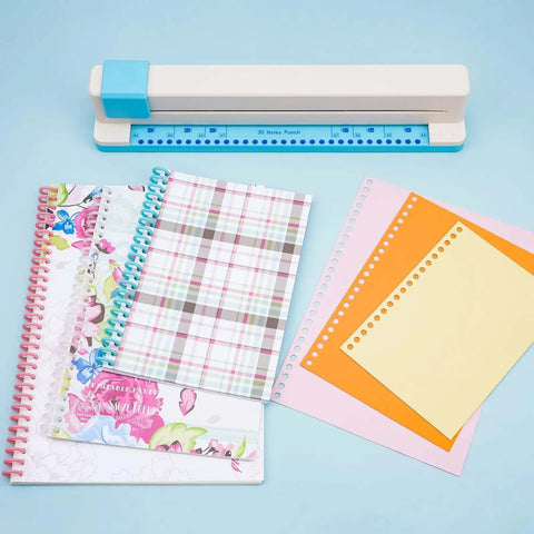 Adjustable 30 Hole Binding Punch For Discbound Notebooks And Journals with planners and pages on a desk