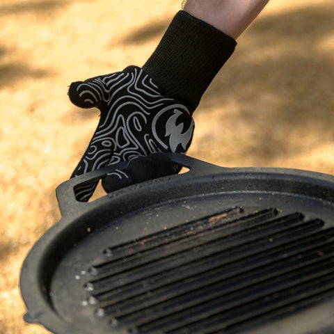 High Heat Grill Gloves For Cooking And BBQ, Oven Mitts With Universal Fit, Non Slip Grip, holding a black grill