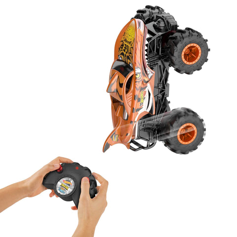Monster Trucks RC Tiger Shark One Twenty Four Scale Remote Control Truck With Terrain Action Tires controlled by hands