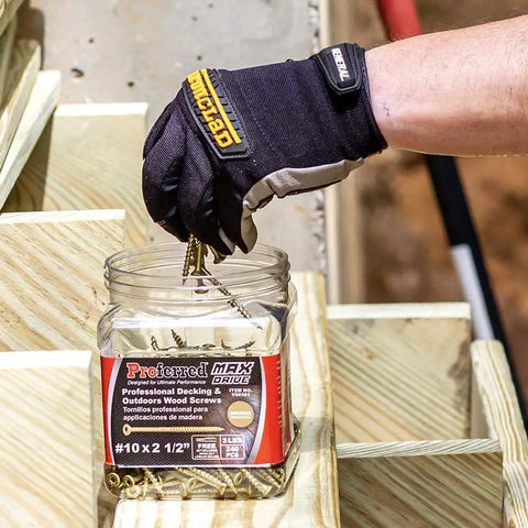 Gloved hand using MAX Drive Exterior Decking And Outdoor Wood Screws With Bronze SKT Coating For Exterior Wood 2.5 Inch #10