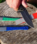 DiaSharp Diamond Mini Hone Sharpening Kit with coarse, fine, extra-fine grit stones sharpening knife on wooden stump