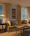 Living room with stained glass Tiffany style table lamp, 16 inch cream shade, next to beige sofa, cozy home office vibe