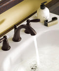 Oil-Rubbed Bronze Two-Handle Widespread Bathroom Faucet Trim Kit For 3-Hole Deck Mount Adjustable 8 To 16 Inch Spread Requires Valve 9000 Brantford Style T6620ORB installed on a white basin.