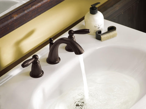 Oil-Rubbed Bronze Two-Handle Widespread Bathroom Faucet Trim Kit For 3-Hole Deck Mount Adjustable 8 To 16 Inch Spread Requires Valve 9000 Brantford Style T6620ORB installed on a white basin.