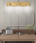 Interiors showcasing Slick Gold Vanity Light With 3 Lights For Bathroom Over Mirror Modern Wall Sconce With Clear Glass Shades.