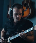 Musician using Dope Tone Wired Smart Guitar Headphone Amp With Custom Audio Drivers Noise Isolation Bluetooth Streaming And AI Powered App For Electric Acoustic And Bass Guitars