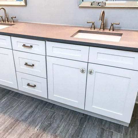 Modern bathroom vanity with white cabinetry, gold hardware fixtures, and a neutral countertop featuring Six Piece Vintage Floral Ceramic Pull Knobs Freakin Gorgeous Red Tulip Drawer Handles Hella Durable Rustic Farmhouse Cabinet Hardware Big Time Kitchen Cupboard Decor Upgrade.