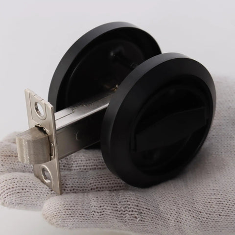 Sleek Stainless Steel Low Profile Door Knobs With Butter Smooth Nonlocking Flat Handle And Hidden Recessed Cup Shape Fast Mount Pocket Entry Handle Set Includes Black Chicago Screws For Rock Solid Grip shown from an angle in hand.