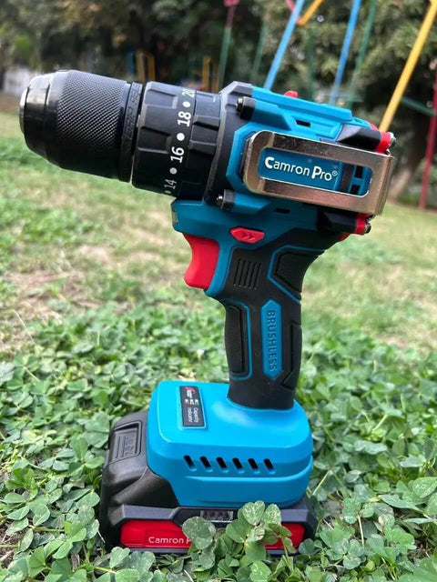 Heavy Duty Cordless Drill Driver With Ten Speed Torque Settings And Included Battery in blue and black on green grass.