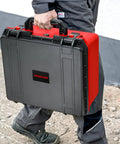 Man carrying Waterproof Hard Case For M18 Cordless Tire Inflator 2848-20, black and red durable storage box with handle