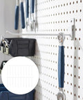 Heavy Duty White Iron Slatwall Hooks Set 20 Pcs 4mm Rod Thickness 7.48 Inch Length Smooth Finish Stable Load Bearing For Retail Displays And Garage Organization On Slatwall installed on pegboard with tools hanging.