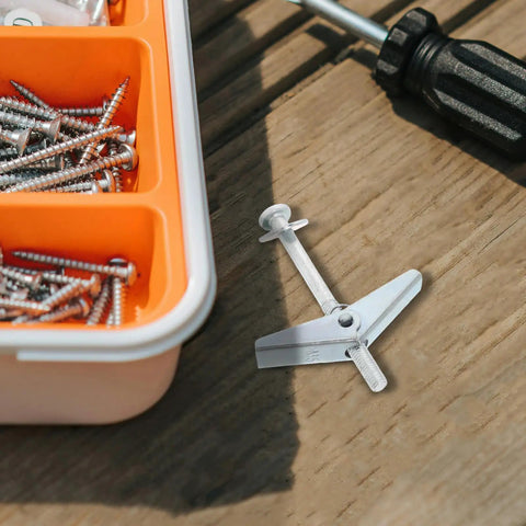 Top Shelf 30 Piece Carbon Steel Drywall Anchors M5 X 60mm Butterfly Toggles on a wooden surface with screws and a screwdriver.