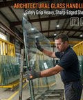 Man wearing Two Pairs A9 Cut Resistant Work Gloves For Men With Touchscreen Capability Reinforced Thumb And Premium HPPE Steel Fiber Blend ANSI Level 9 Protection Against Metal Glass Wood Construction And Fishing XL handling glass sheets in a warehouse.