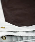 Close-up of a 20 Foot By 20 Foot Beefy Tough As Nails Waterproof Tarp 16 Mil Thick White And Brown Reversible Cover with reinforced corners.