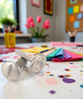 Top Tier 100 Pack 8mm Slotted Phillips Head Screw Brads In Sleek Silver on craft table with colorful papers and decorations.