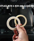 58mm Silicone Steam Ring Set Of 2 for Breville and Sage Espresso Machines gasket held in hand with coffee machine in background