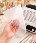 Hand holding 1000 Sheets Nail Dust Collector Filter Paper For Most Nail Dust Fan Extractor Machines Disposable Nail Dust Vacuum Filter Pack