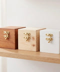 Wooden boxes with gold Vintage Swing Bag Clasp Closure Lock Retro Latch For Jewelry Boxes And Wooden Chests on a shelf.