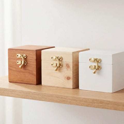 Wooden boxes with gold Vintage Swing Bag Clasp Closure Lock Retro Latch For Jewelry Boxes And Wooden Chests on a shelf.