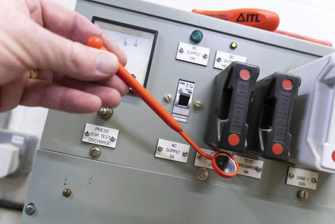Person using Pro Grade Fully Insulated Live Line Inspection Mirror in Bright Orange, no-metal build, for electric panel inspection.