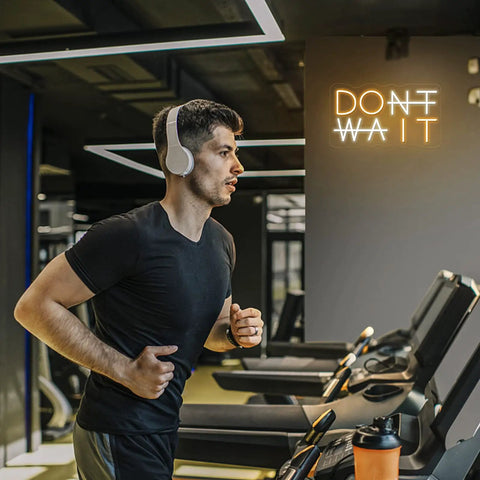 Man jogging in gym with Don't Wait LED Neon Sign Wall Decor Do It Neon Light USB Powered Adjustable Brightness on wall
