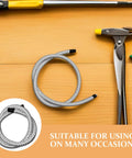 Heavy Duty Garment Steamer Hose Replacement, 1 Meter High Temp Flexible Steam Tube, black and white, coiled on a wooden surface.
