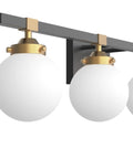 Close-up of Four Light Mid Century Modern Bathroom Vanity Light Fixtures Over Mirror In Black And Gold With Milk White Glass Globes Wall Mount