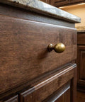 Oval Antique Brass Cabinet Knobs Set 1.6 Inch Zinc Alloy Drawer Knobs for dresser shown in close-up on wooden drawer