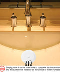 Slick Six Inch Silicone Tub Stopper Two Pack Soft Drain Plug Hair Catcher placed on a bathroom sink drain, showing installation ease.