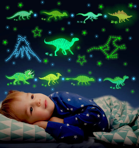 Child in a stars pajamas gazing at Glow In The Dark Dinosaur Wall Decals For Boys Room Pack Of 652 Pcs Dinosaur Wall Stickers with dinosaurs and stars