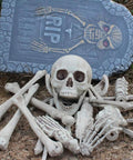 28 Piece Skeleton Bones And Skull Set For Halloween Decor Spooky Graveyard Ground Props with tombstone backdrop