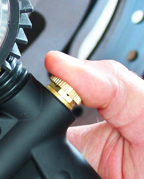 Close-up of hand adjusting Beefy Analog Pistol Grip Tire Inflator Gauge With Dual Head Chuck And 15 Inch Hose Liquid Filled Gauge