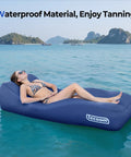 Inflatable Lounger Couch Air Sofa Hammock No Pump Needed 20 Second Inflation Waterproof Beach Chair on water with a person tanning