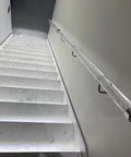 Heavy Duty Clear Acrylic Railing System for Decks Patios and Balconies mounted on stylish marble stairs with LED lighting.
