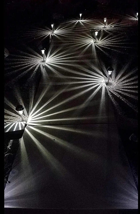 Sweet 6 Pack Silver Solar Path Lights With Glass Lens And Metal Ground Stakes illuminating a path with starburst pattern