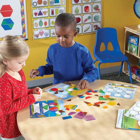 Children playing with Shapes Dont Bug Me Geometry Activity Set With 136 Pieces For Kids Ages 5 And Up in a classroom setting.