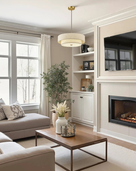 18 Inch Modern Drum Chandelier 4 Light Two Tier Linen Pendant With Brushed Gold Canopy illuminating a cozy living room.