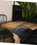 Solid As A Rock Heavy Duty Replacement Attachment Plates For Sofa Couch And Table Legs with hand holding black metal bracket.