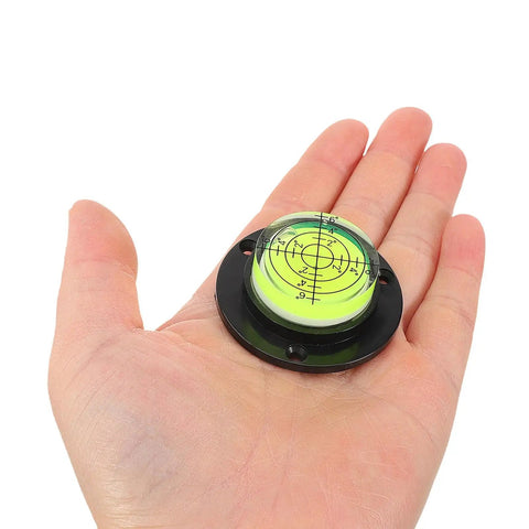 4pcs Acrylic Cylindrical Mini Spirit Level Tool for Precise Measuring in hand, featuring bubble level for accurate measuring.