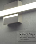 Close-up of modern chrome vanity light over mirror, stainless steel with matte white acrylic shade, part of 12W two pack set.