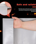 Person holding Emergency Fireproof Hooded Cloak For Quick Fire Escape, Life Saver Silver Silicone Coated Fiberglass Fire Blanket showing reinforced handles.