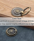 Vintage Oil Rubbed Bronze Ring Pulls for Cabinets and Drawers, 2 Inch Diameter, shown on wood surface and textile background
