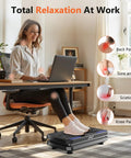 Woman using Vibration Plate Fitness Platform for full body workout and lymphatic drainage, sitting at desk with laptop, home office setup.
